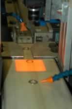 Deficient rings are blown off the conveyor. Deficient rings are blown off the conveyor.